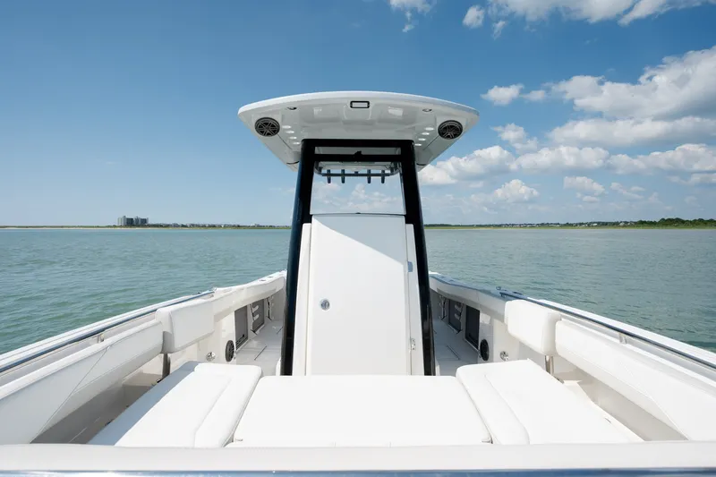 Slide: The Image of 2026 World Cat 265 CC-X boat on calm water under blue sky. - 20