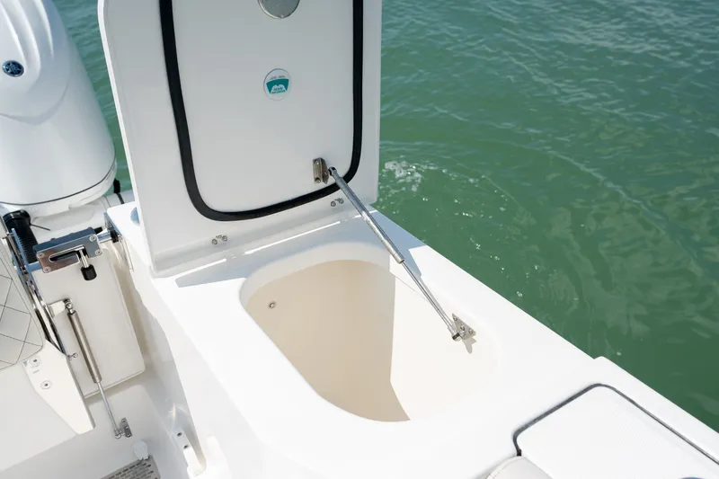 Slide: The Image of Open storage compartment on 2026 World Cat 265 CC-X boat, near water. - 46