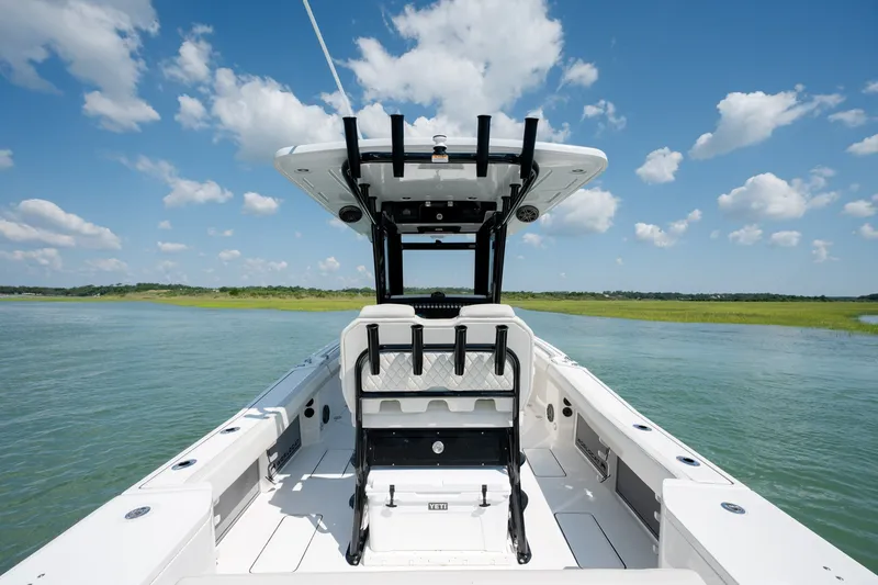 Slide: The Image of 2026 World Cat 265 CC-X boat on serene water under a clear blue sky. - 31