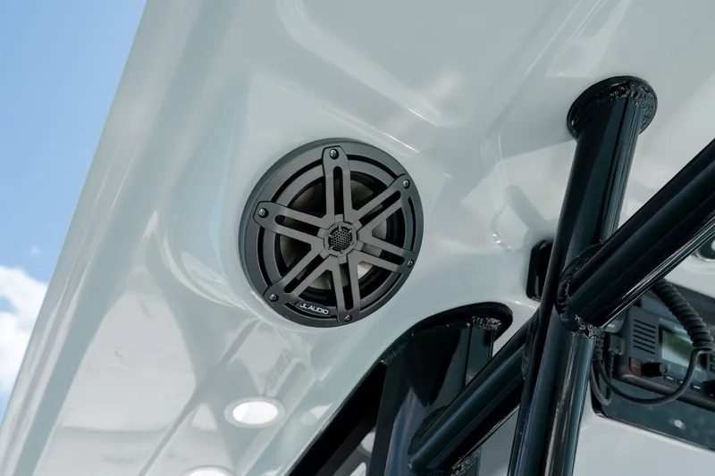 Slide: The Image of 2026 World Cat 265 CC-X boat speaker system, featuring JL Audio, under a sleek canopy. - 26