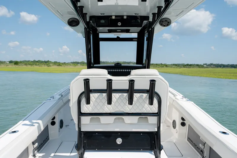 Slide: The Image of 2026 World Cat 265 CC-X boat interior with seating, on a calm waterway. - 30
