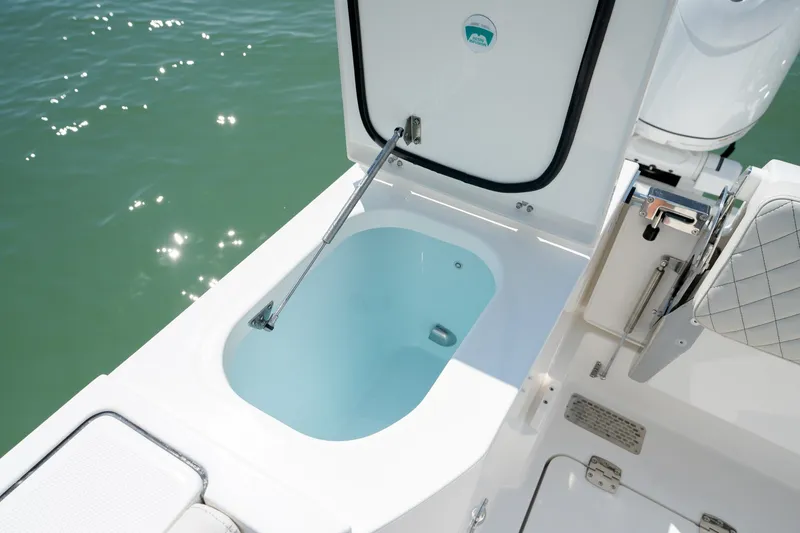 Slide: The Image of Livewell on 2026 World Cat 265 CC-X boat, open lid, near water. - 43