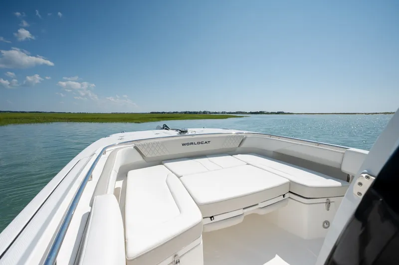 Slide: The Image of 2026 World Cat 265 CC-X boat on serene water, featuring spacious seating and sleek design. - 14