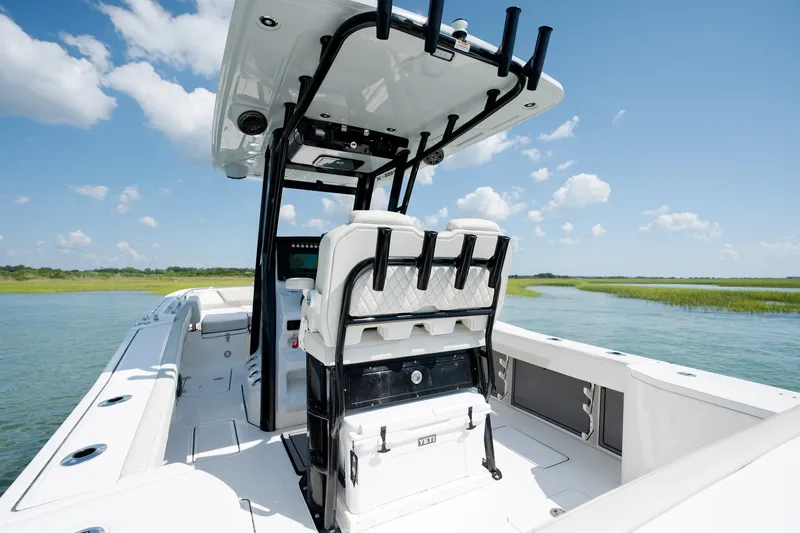 Slide: The Image of 2026 World Cat 265 CC-X boat on calm water under a clear blue sky. - 32