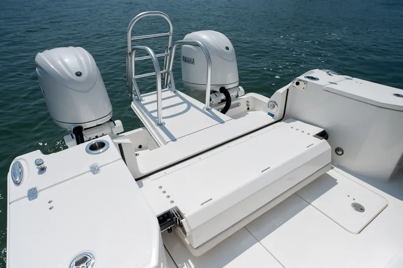 Slide: The Image of 2026 World Cat 265 CC-X boat with dual Yamaha engines and swim ladder on open water. - 44