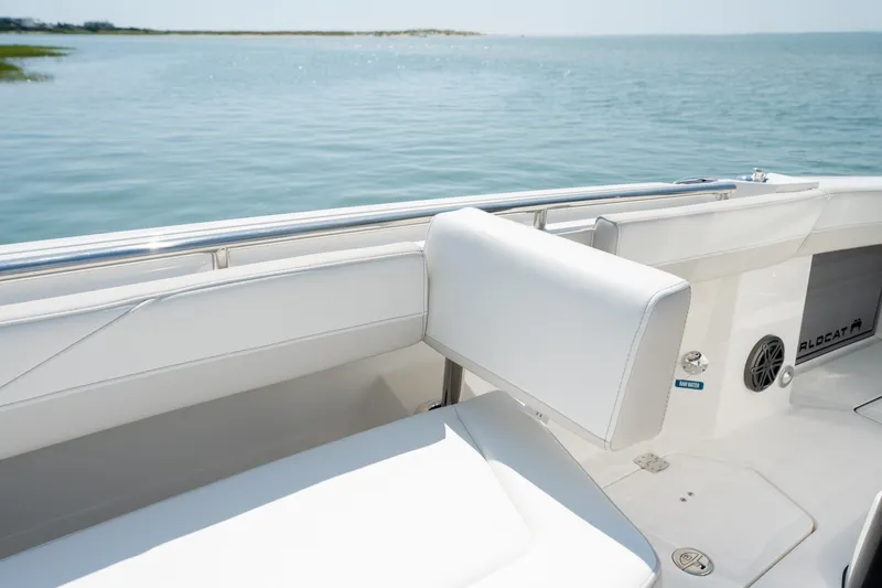 Slide: The Image of 2026 World Cat 265 CC-X boat interior with white seating and ocean view. - 18