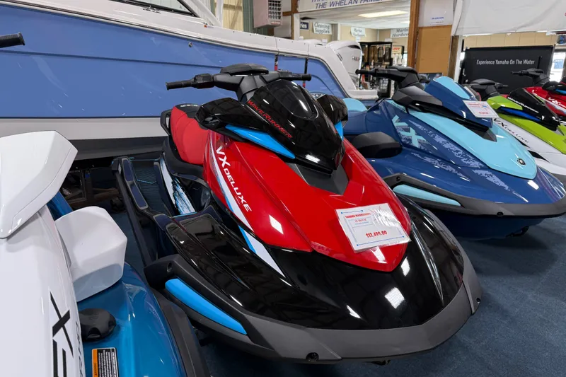 Slide: The Image of 2026 Yamaha WaveRunner VX Deluxe in showroom, featuring sleek red and black design. - 1