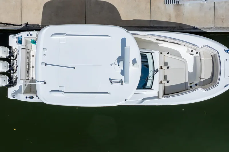 Slide: The Image of Overhead view of a 2019 Boston Whaler 350 Realm docked, showcasing sleek design and spacious layout. - 19
