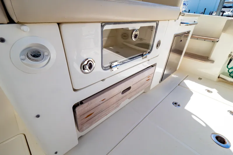Slide: The Image of 2019 Boston Whaler 350 Realm interior, featuring storage compartments and sleek design elements. - 82