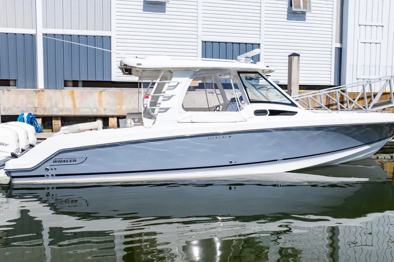 Slide: The Image of 2019 Boston Whaler 350 Realm boat docked at marina, side view. - 53