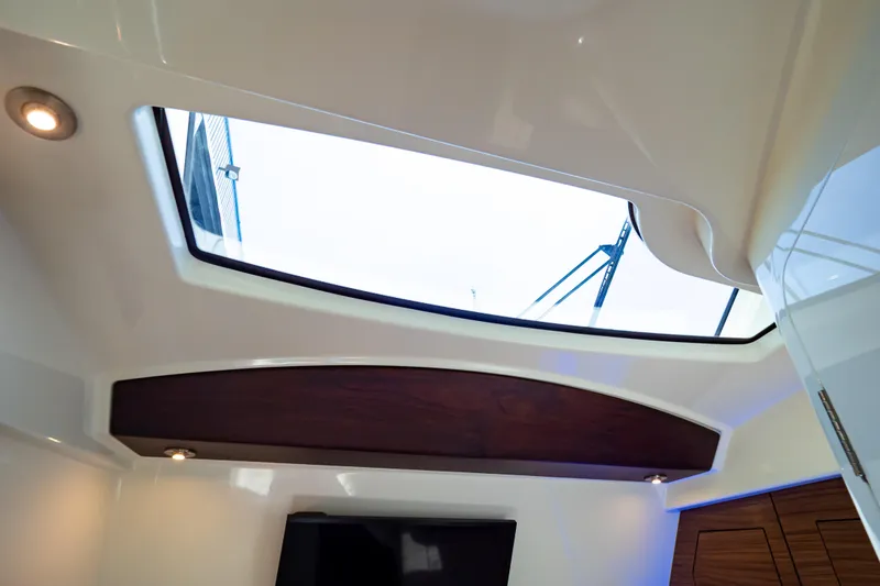 Slide: The Image of Interior view of 2019 Boston Whaler 350 Realm with skylight and modern lighting. - 30
