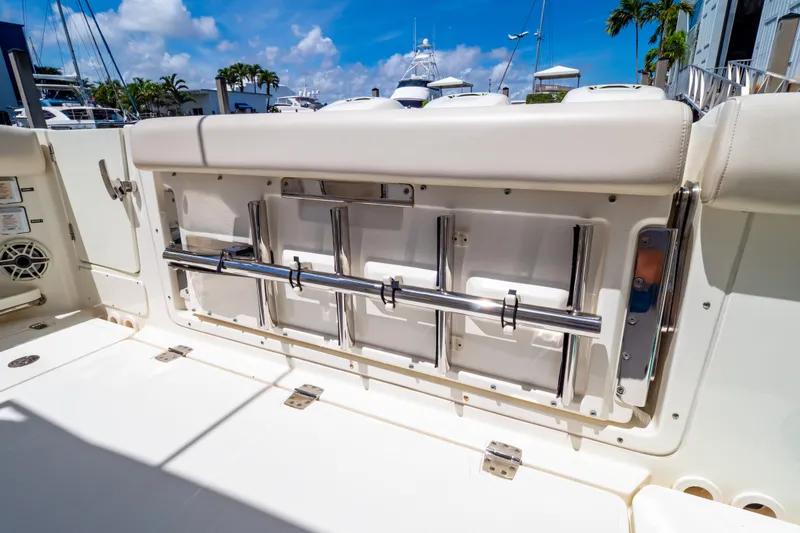 Slide: The Image of 2019 Boston Whaler 350 Realm boat interior with stainless steel fittings and cushioned seating. - 50