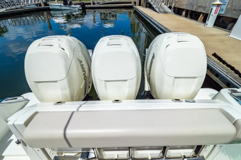 Slide: The Image of 2019 Boston Whaler 350 Realm with triple Mercury outboard engines docked at marina. - 43