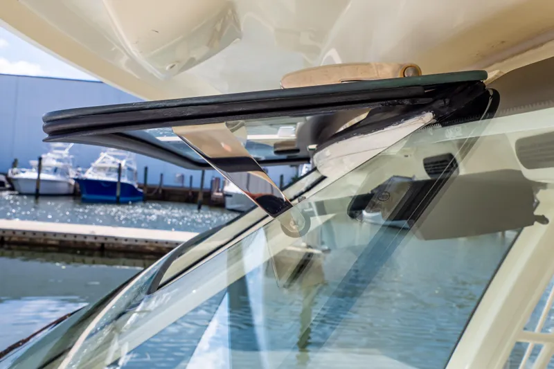 Slide: The Image of Close-up of 2019 Boston Whaler 350 Realm windshield detail at marina. - 104