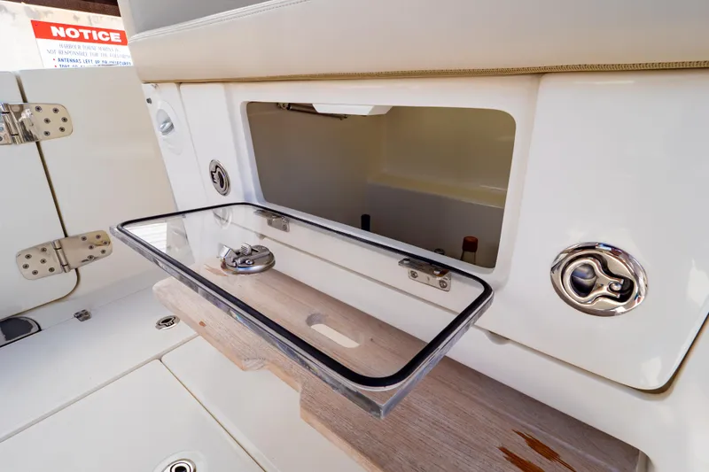 Slide: The Image of Open storage compartment on 2019 Boston Whaler 350 Realm boat, showcasing sleek design. - 79