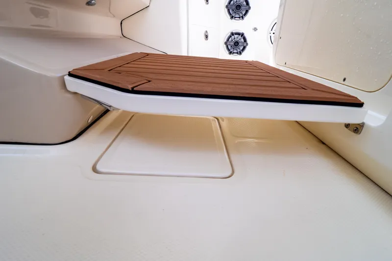 Slide: The Image of 2019 Boston Whaler 350 Realm interior with wooden platform and speakers. - 89