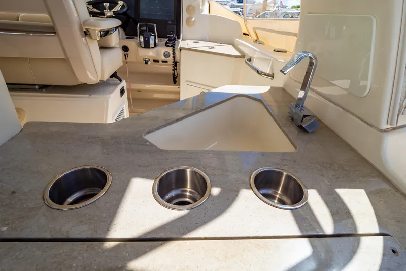 Slide: The Image of 2019 Boston Whaler 350 Realm interior with sink and cup holders. - 86