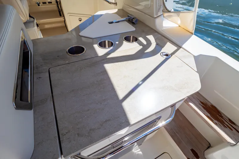 Slide: The Image of 2019 Boston Whaler 350 Realm boat interior with sleek countertop and cup holders. - 84