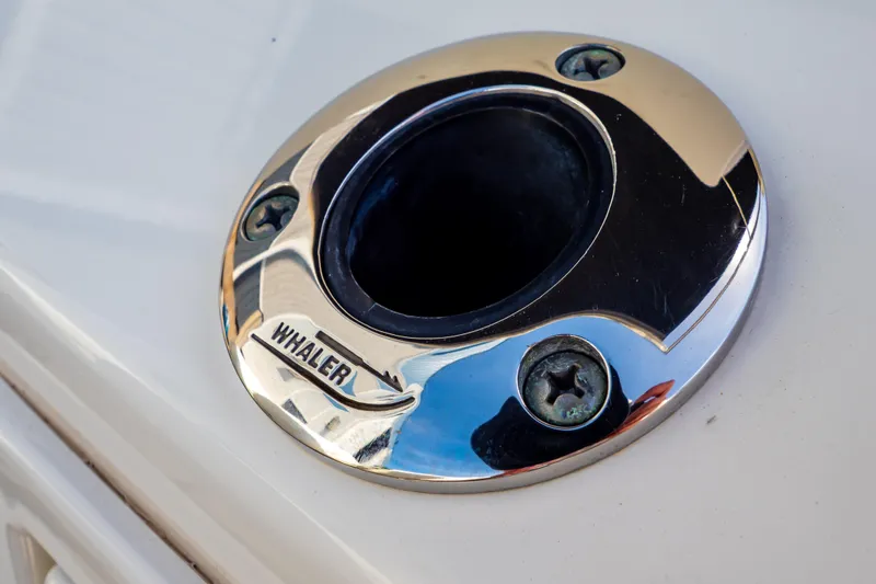 Slide: The Image of Chrome boat fitting on 2019 Boston Whaler 350 Realm, featuring "Whaler" engraving. - 60