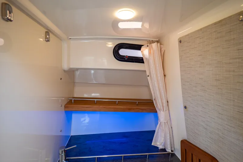 Slide: The Image of Interior cabin of 2019 Boston Whaler 350 Realm with ambient lighting and curtain. - 31