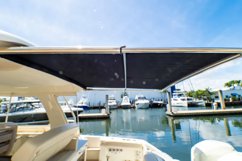 Slide: The Image of Boston Whaler 350 Realm 2019 with extended sunshade at marina. - 55