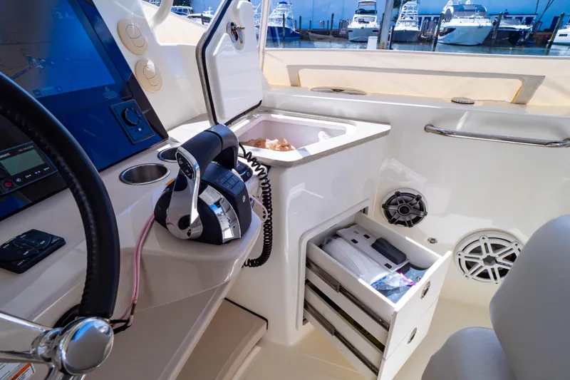 Slide: The Image of Interior view of 2019 Boston Whaler 350 Realm boat with control panel and storage. - 96