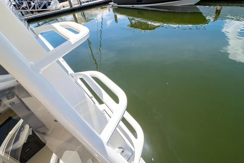 Slide: The Image of Boston Whaler 350 Realm boat docked, reflecting on calm water, 2019 model. - 52
