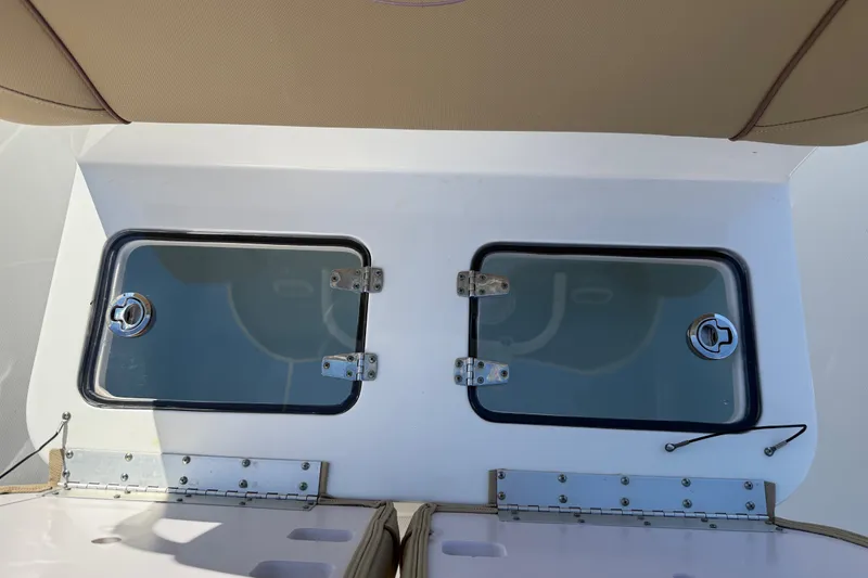 Slide: The Image of 2018 Sea Hunt Gamefish 27 boat storage compartments with secure latches and sleek design. - 24