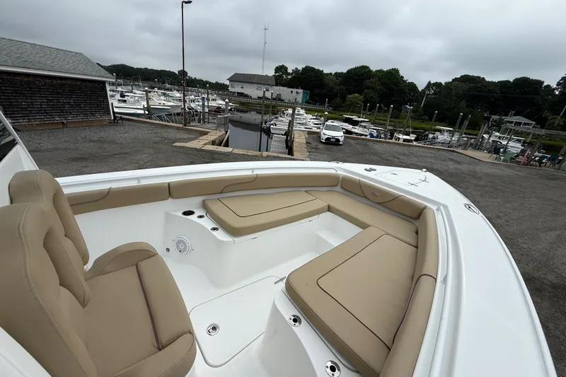 Slide: The Image of 2018 Sea Hunt Gamefish 27 boat with tan seating at a marina. - 15
