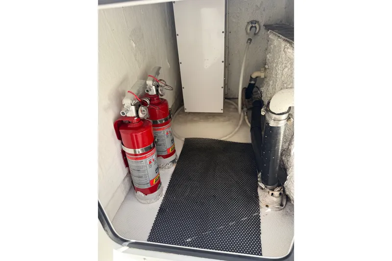 Slide: The Image of Interior of a 2018 Sea Hunt Gamefish 27 boat with fire extinguishers and plumbing. - 27