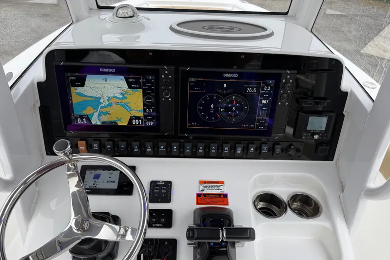 Slide: The Image of 2018 Sea Hunt Gamefish 27 dashboard with dual Simrad displays and modern controls. - 16