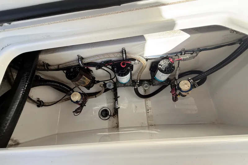 Slide: The Image of 2018 Sea Hunt Gamefish 27 boat compartment with pumps and wiring. - 21