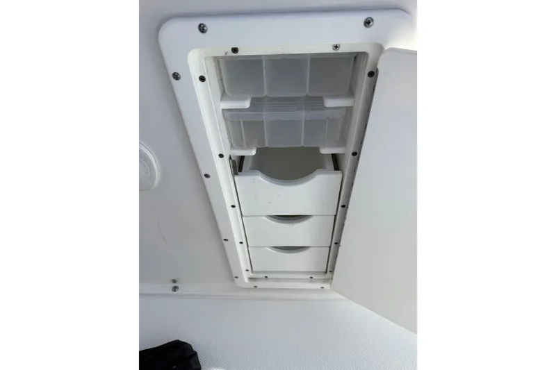 Slide: The Image of Storage compartment on a 2018 Sea Hunt Gamefish 27 boat, featuring organized drawers. - 26