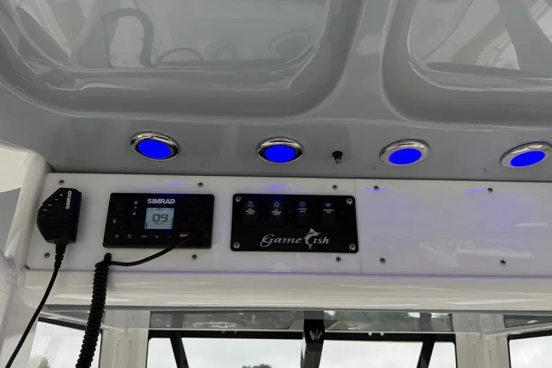 Slide: The Image of 2018 Sea Hunt Gamefish 27 dashboard with Simrad display and blue LED lights. - 17