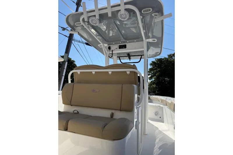 Slide: The Image of 2018 Sea Hunt Gamefish 27 boat interior with cushioned seating and overhead console. - 14