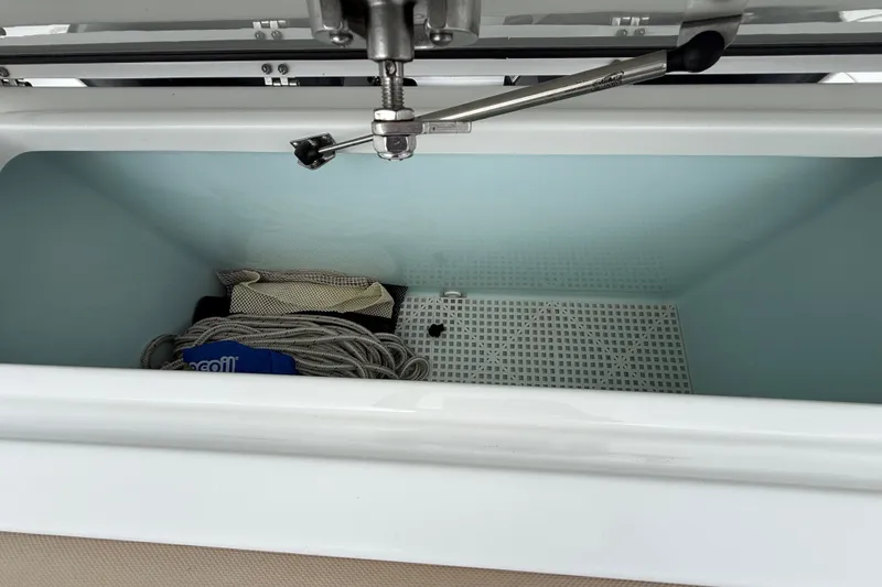 Slide: The Image of Open storage compartment on a 2018 Sea Hunt Gamefish 27 boat, containing ropes and netting. - 19