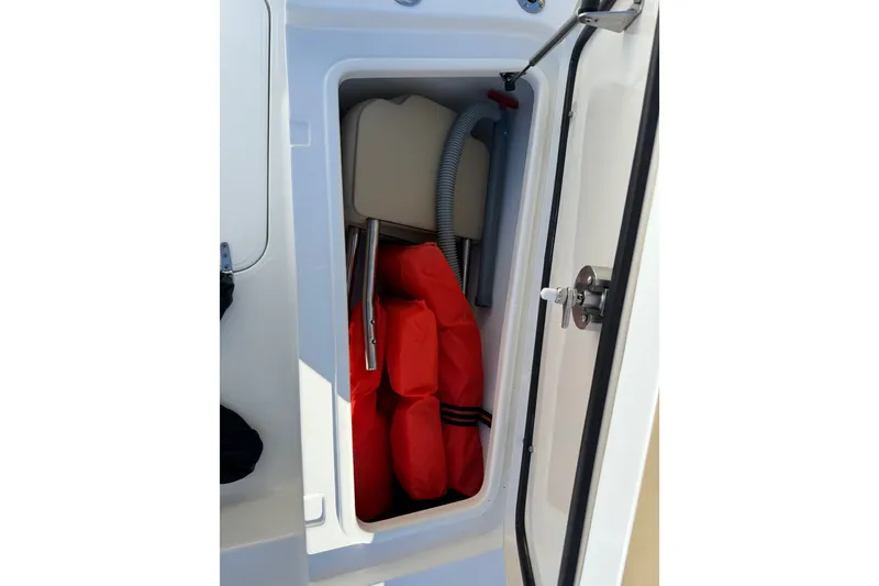 Slide: The Image of Storage compartment on a 2018 Sea Hunt Gamefish 27 boat with life jackets. - 29