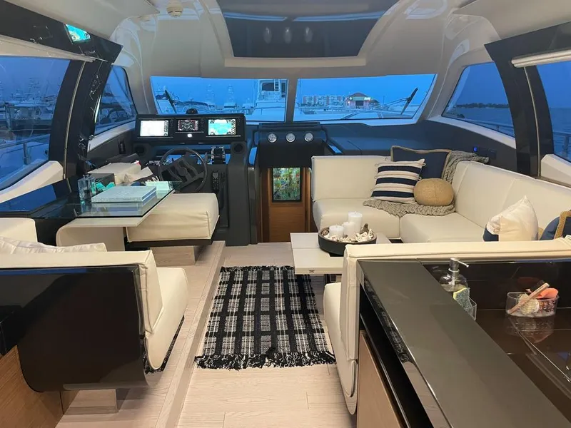 Slide: The Image of Luxurious interior of a 2016 Ferretti Yachts 550 with modern furnishings and panoramic windows. - 22