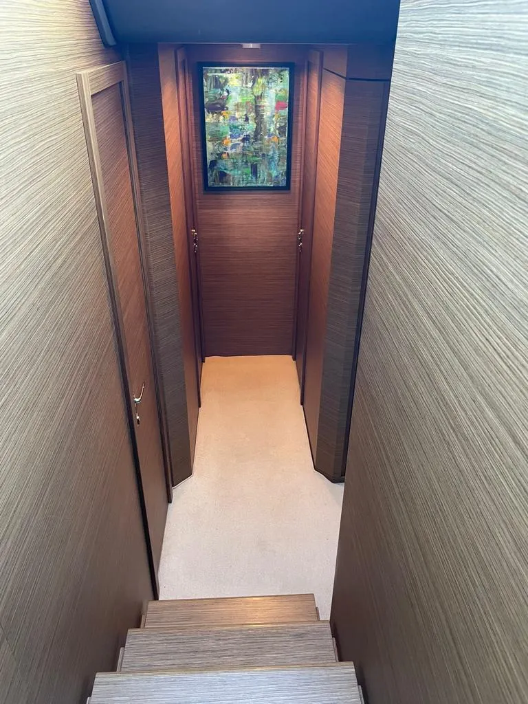 Slide: The Image of Interior hallway of 2016 Ferretti Yachts 550 with wooden paneling and artwork. - 21