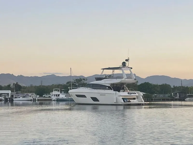 Slide: The Image of 2016 Ferretti Yachts 550 cruising on calm waters at sunset. - 1