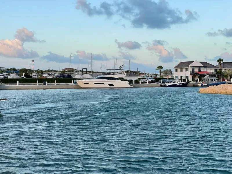 Slide: The Image of Ferretti Yachts 550 (2016) docked in a serene marina with blue skies. - 6