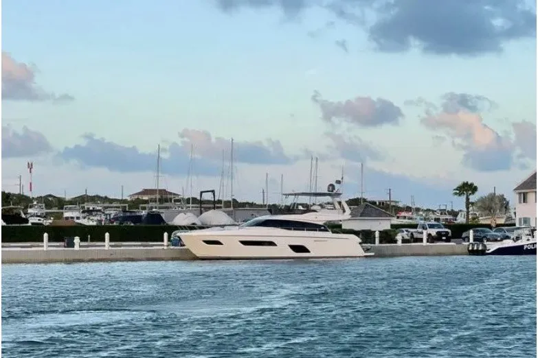 The Image of 2016 Ferretti Yachts 550 docked at a marina under a cloudy sky. - 0