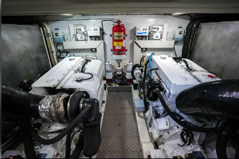 Slide: The Image of Engine room of a 2016 Ferretti Yachts 550 with dual engines and fire extinguisher. - 25