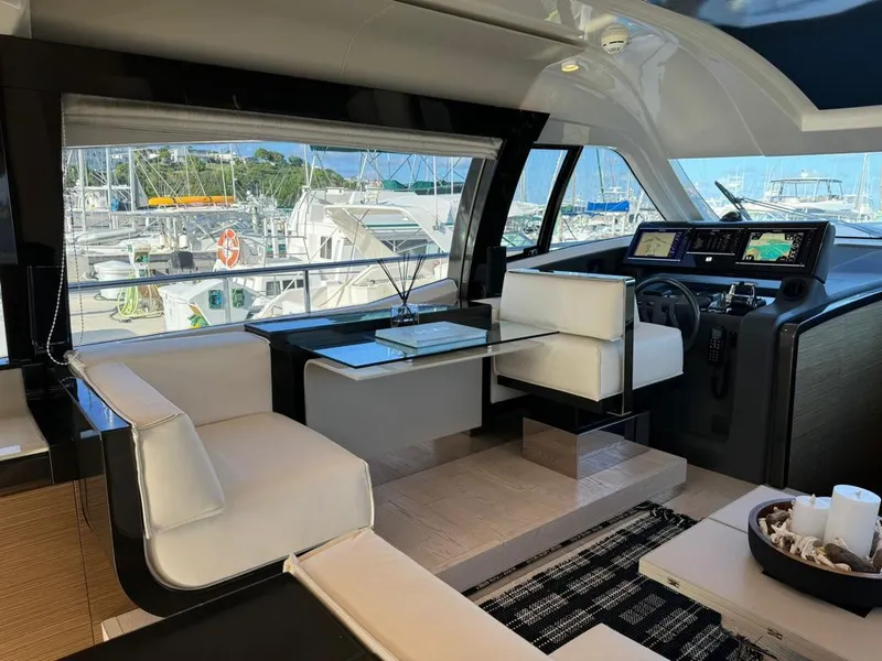Slide: The Image of Luxurious interior of 2016 Ferretti Yachts 550 with modern seating and navigation area. - 11
