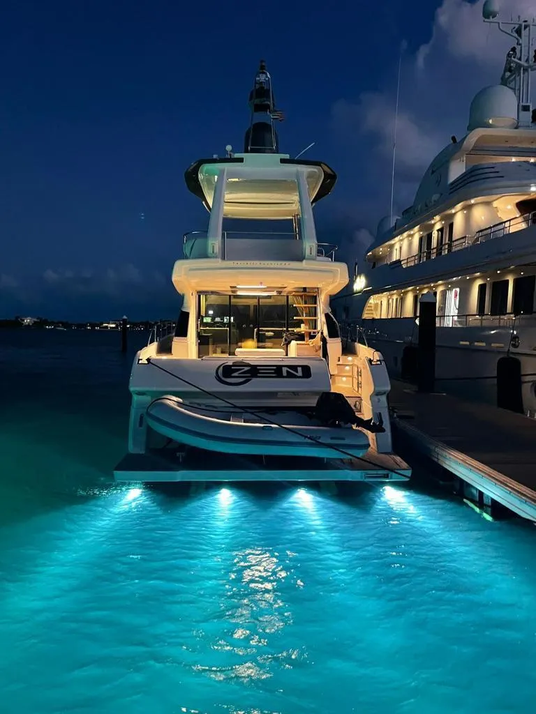 Slide: The Image of 2016 Ferretti Yachts 550 illuminated at night in marina. - 7