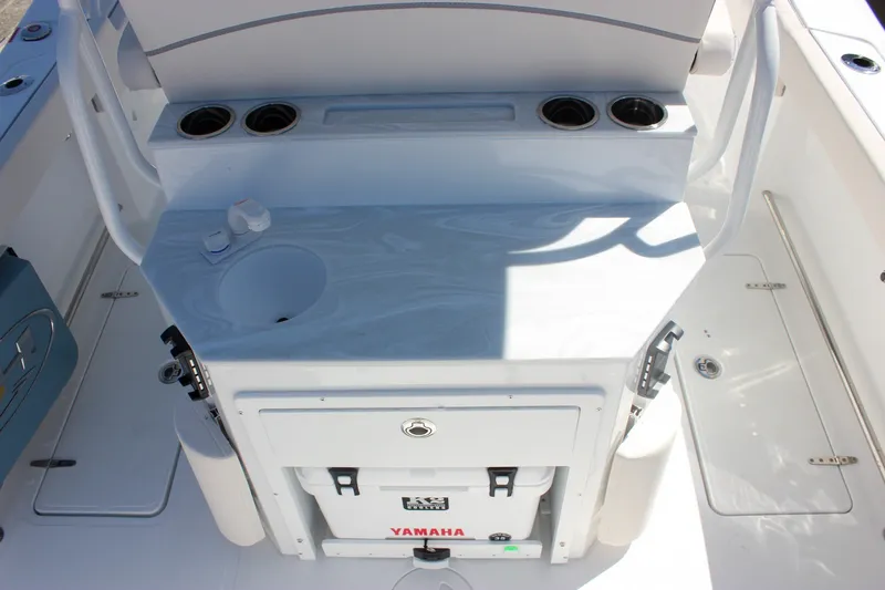 Slide: The Image of Interior view of 2027 Sea Hunt Ultra 265SE boat with Yamaha cooler and cup holders. - 12