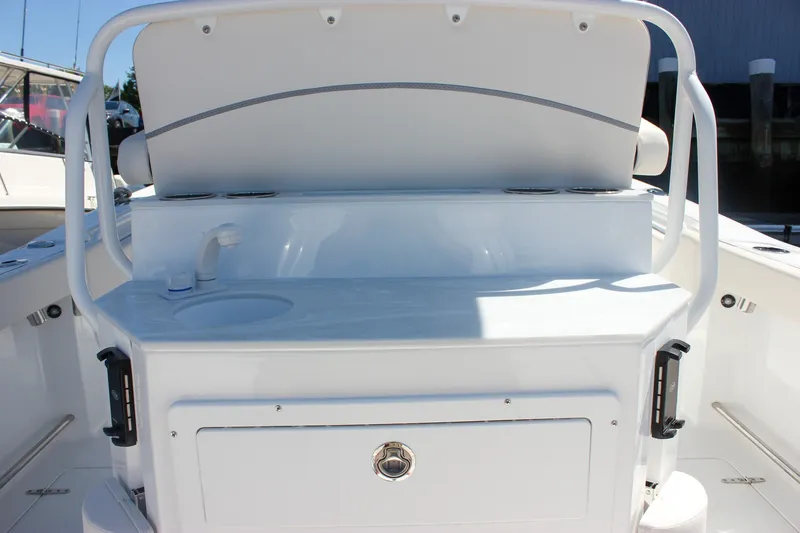 Slide: The Image of 2027 Sea Hunt Ultra 265SE boat interior with sink and storage compartment. - 17