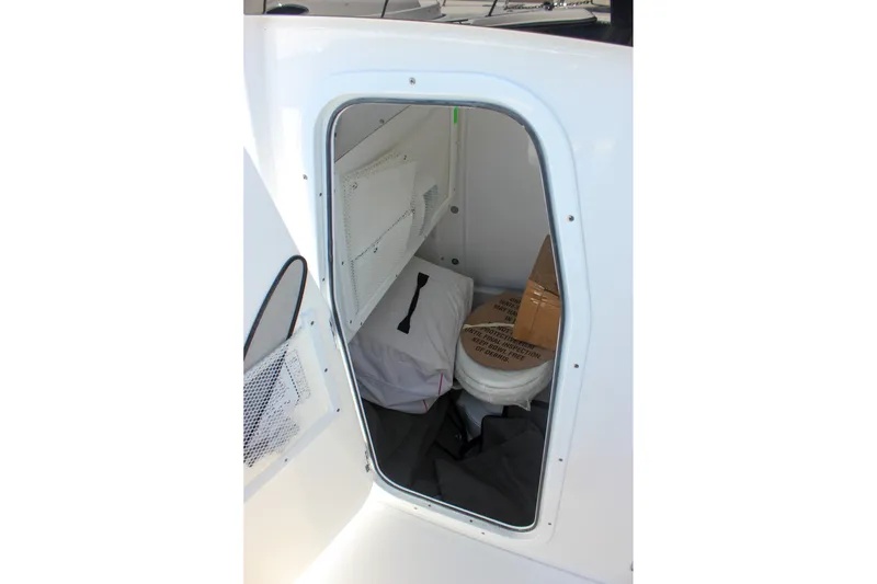 Slide: The Image of Interior storage compartment of 2027 Sea Hunt Ultra 265SE boat, featuring organized space. - 43