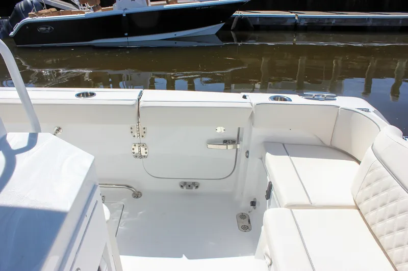 Slide: The Image of Interior view of 2027 Sea Hunt Ultra 265SE boat with white seating and deck. - 10
