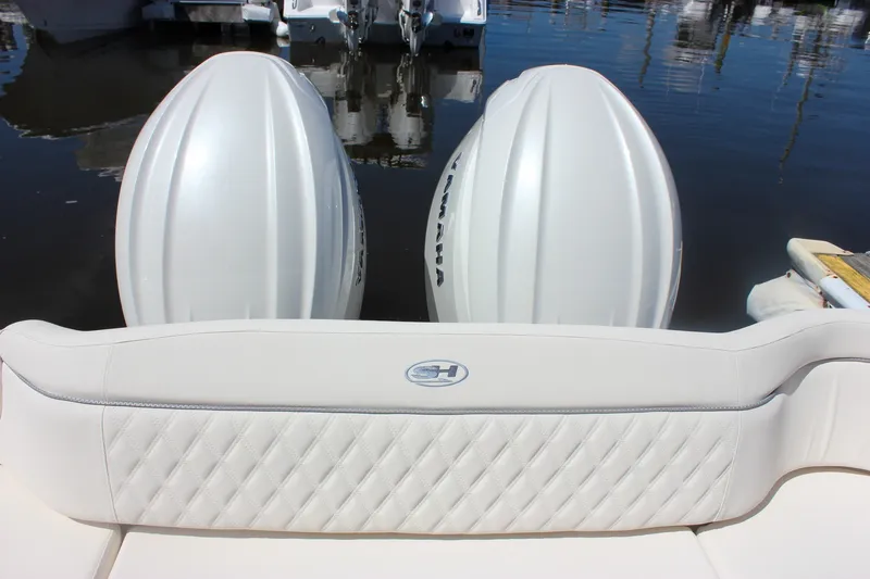 Slide: The Image of 2027 Sea Hunt Ultra 265SE boat with twin Yamaha engines at dock. - 8